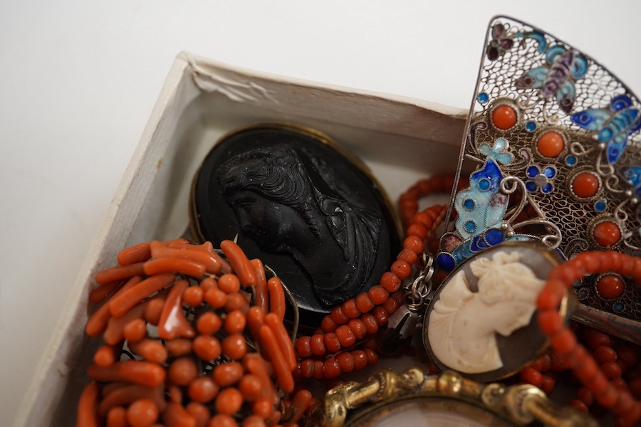 A Victorian yellow metal and coral bead set mourning brooch, with plaited hair beneath a glazed panel, 22mm, a filigree 925, coral and enamel set fan brooch and six other items including a coral branch and bead cluster b